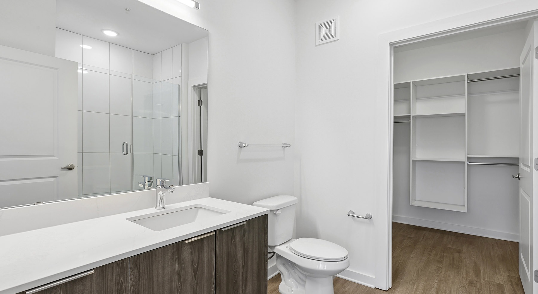 bath with vanity mirror and closet