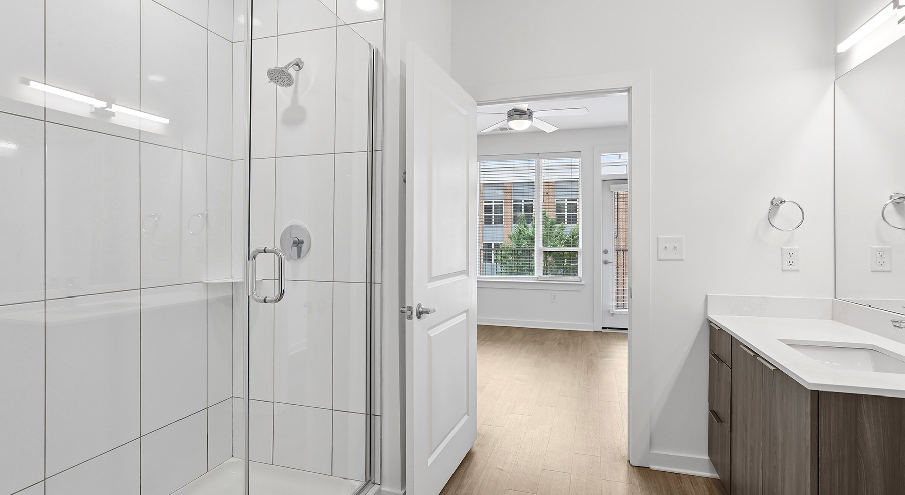 bath with glass enclosed shower