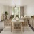 a dining room with a white table and chairs