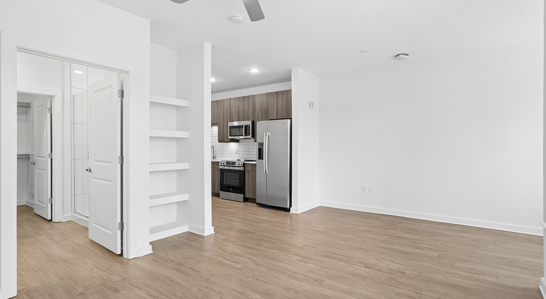 large room with white walls and wood floors